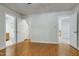 Open bedroom with hardwood floors and multiple open doorways to closets and bathroom at 108 Ellsworth Pl, Chapel Hill, NC 27516