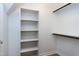 Walk-in closet with built in shelving and hanging racks for optimal storage at 108 Ellsworth Pl, Chapel Hill, NC 27516