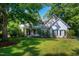 Charming home with a lush green lawn, mature trees, and a welcoming front porch area at 108 Ellsworth Pl, Chapel Hill, NC 27516