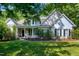Charming home featuring a welcoming front porch, manicured landscaping and classic architectural details at 108 Ellsworth Pl, Chapel Hill, NC 27516