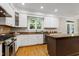 Beautiful kitchen with a view of a window, stainless steel appliances, and custom cabinetry at 108 Ellsworth Pl, Chapel Hill, NC 27516