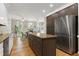Bright, open kitchen and dining area with stainless steel appliances and hardwood floors at 108 Ellsworth Pl, Chapel Hill, NC 27516