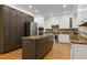 The modern kitchen features custom island, stainless appliances and plenty of cabinet space at 108 Ellsworth Pl, Chapel Hill, NC 27516