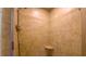 Shower stall with decorative tile accent and a built-in shelf in bathroom at 108 Ellsworth Pl, Chapel Hill, NC 27516