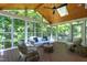 Inviting sunroom with vaulted wood ceiling and many windows, creating a peaceful retreat at 108 Ellsworth Pl, Chapel Hill, NC 27516