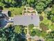 Aerial view of the home featuring beautiful landscaping, a deck, and a firepit at 10909 Raven Rock Dr, Raleigh, NC 27614