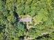 Aerial view of the house and lot surrounded by mature trees offering privacy at 10909 Raven Rock Dr, Raleigh, NC 27614