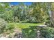 Tranquil backyard with a lush green lawn, complemented by mature trees at 10909 Raven Rock Dr, Raleigh, NC 27614