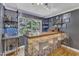 Finished basement with a bar area that has a natural stone base and views of the outdoors at 10909 Raven Rock Dr, Raleigh, NC 27614