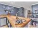 Finished basement bar with hardwood floors, natural light, and unique decorations at 10909 Raven Rock Dr, Raleigh, NC 27614