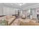 A cozy basement living area with wicker furniture, a plush rug, and neutral paint, perfect for relaxation at 10909 Raven Rock Dr, Raleigh, NC 27614