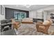 Finished basement with a black accent wall, sliding glass doors and wicker furniture at 10909 Raven Rock Dr, Raleigh, NC 27614