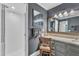 Bathroom with gray walls, tiled floors, a walk-in shower, vanity with sink and framed mirrors at 10909 Raven Rock Dr, Raleigh, NC 27614