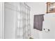 A bright bathroom showcasing a shower with patterned curtain and a towel rack, designed for comfort and convenience at 10909 Raven Rock Dr, Raleigh, NC 27614