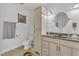 A clean bathroom featuring white cabinetry, a toilet, a sink with a mirror, and neutral tones at 10909 Raven Rock Dr, Raleigh, NC 27614