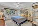 A relaxing bedroom features a large window with scenic views and neutral decor at 10909 Raven Rock Dr, Raleigh, NC 27614
