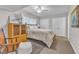 Comfortable bedroom featuring a ceiling fan, plush carpet, and convenient closet space at 10909 Raven Rock Dr, Raleigh, NC 27614