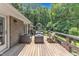 View from elevated deck with outdoor seating, gas firepit and wooded view at 10909 Raven Rock Dr, Raleigh, NC 27614