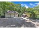 Gravel driveway featuring a two-car garage, a separate two-car garage, and parking for vehicles at 10909 Raven Rock Dr, Raleigh, NC 27614