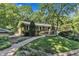 Exterior view of a brick ranch-style home with a two-car garage and landscaped front yard at 10909 Raven Rock Dr, Raleigh, NC 27614