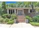 Inviting front entrance with brick steps, double doors, manicured landscaping, and stylish planters at 10909 Raven Rock Dr, Raleigh, NC 27614