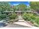 Charming one-story brick home with an American flag, lush landscaping, and inviting walkway at 10909 Raven Rock Dr, Raleigh, NC 27614