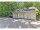 Detached garage with three bays, siding and a gravel parking area at 10909 Raven Rock Dr, Raleigh, NC 27614