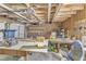 Unfinished garage featuring a workbench, exposed rafters, and an open overhead door at 10909 Raven Rock Dr, Raleigh, NC 27614