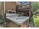 View of bubbling jacuzzi below an elevated deck overlooking the backyard at 10909 Raven Rock Dr, Raleigh, NC 27614