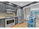 The kitchen offers modern appliances, gray cabinets, and access to a dining area at 10909 Raven Rock Dr, Raleigh, NC 27614