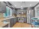 This is a kitchen that features stainless steel appliances, stone countertops, and natural light at 10909 Raven Rock Dr, Raleigh, NC 27614