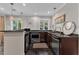 Modern kitchenette with stainless steel appliances, granite countertops, and ample lighting perfect for entertaining at 10909 Raven Rock Dr, Raleigh, NC 27614