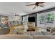 The open living room features hardwood floors, comfortable seating, and access to the outdoor deck at 10909 Raven Rock Dr, Raleigh, NC 27614