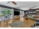 A bright living room featuring hardwood floors, french doors to the deck, and comfortable seating at 10909 Raven Rock Dr, Raleigh, NC 27614