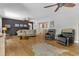 Spacious living room with hardwood floors, ample seating, a ceiling fan, and natural light at 10909 Raven Rock Dr, Raleigh, NC 27614
