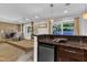 Stylish wet bar with granite counters, mini fridge, and access to the living room with fireplace, ideal for entertaining at 10909 Raven Rock Dr, Raleigh, NC 27614