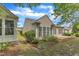 Charming home exterior with beige siding, manicured landscaping, and a cozy patio area at 113 Dowington Ln, Cary, NC 27519