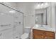 Well-lit bathroom with a glass-enclosed shower, toilet, and vanity with sink at 113 Dowington Ln, Cary, NC 27519