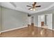 Open bedroom with hardwood flooring, tray ceiling and access to en suite bath and walk-in closet at 113 Dowington Ln, Cary, NC 27519