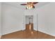 Bedroom with hardwood floors, white walls, ceiling fan and glass paneled french doors leading to the rest of the house at 113 Dowington Ln, Cary, NC 27519