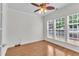 Cozy room featuring hardwood floors, a ceiling fan, and an abundance of natural light at 113 Dowington Ln, Cary, NC 27519