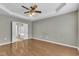Spacious bedroom with a tray ceiling, hardwood floors, and an ensuite bathroom at 113 Dowington Ln, Cary, NC 27519