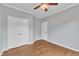 This bedroom offers hardwood floors, a ceiling fan, and a double closet with ample storage at 113 Dowington Ln, Cary, NC 27519