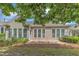 Rear exterior view showcasing a stone patio and the screened-in porch at 113 Dowington Ln, Cary, NC 27519