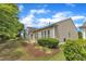 Back exterior of the home with a stone patio and beautiful landscaping at 113 Dowington Ln, Cary, NC 27519