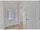 Bright foyer with tiled flooring, complemented by decorative trim and a glass paneled front door at 113 Dowington Ln, Cary, NC 27519
