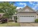 Charming single-story home with a well-manicured lawn and a two-car garage at 113 Dowington Ln, Cary, NC 27519