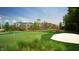 Scenic view of a well-manicured golf course with a clubhouse in the background at 113 Dowington Ln, Cary, NC 27519