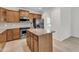 Kitchen features stainless appliances, granite counters, and a center island with cabinetry at 113 Dowington Ln, Cary, NC 27519