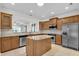 Well-equipped kitchen featuring stainless steel appliances, granite countertops, and a spacious island at 113 Dowington Ln, Cary, NC 27519